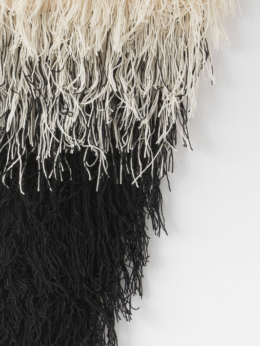 Zen handwoven wool tapestry shown hanging on a wall