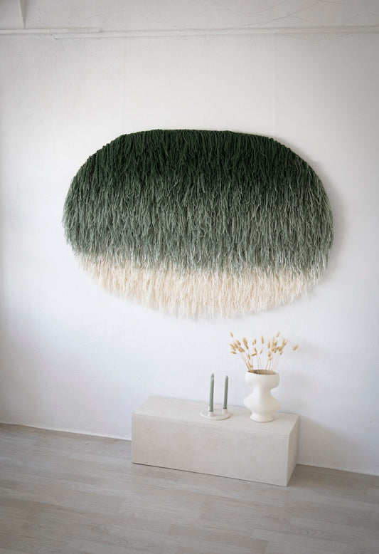 Namii handwoven wool tapestry shown hanging on a wall