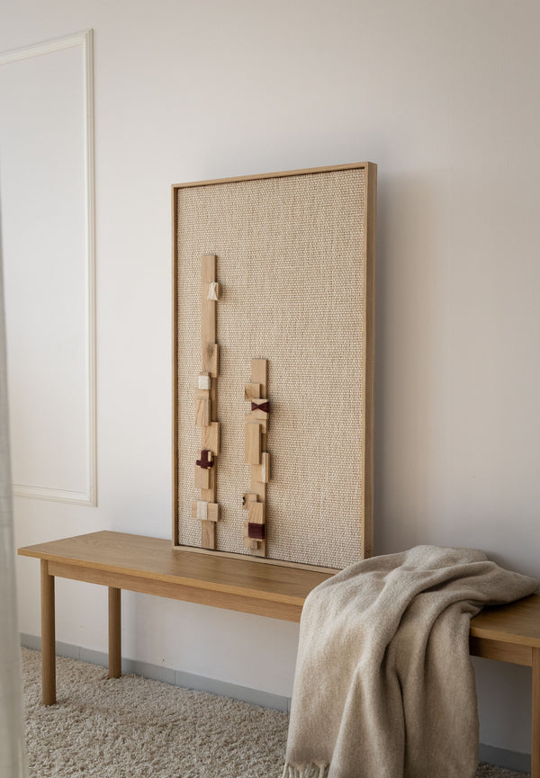 Grainline handwoven wool tapestry shown hanging on a wall