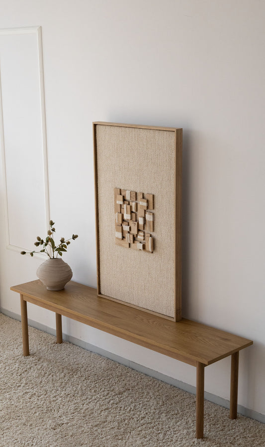 Inlay handwoven wool and oak tapestry shown hanging on a wall