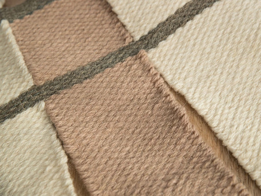 Krado handwoven wool tapestry shown hanging on a wall