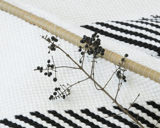 Trian handwoven wool tapestry shown hanging on a wall