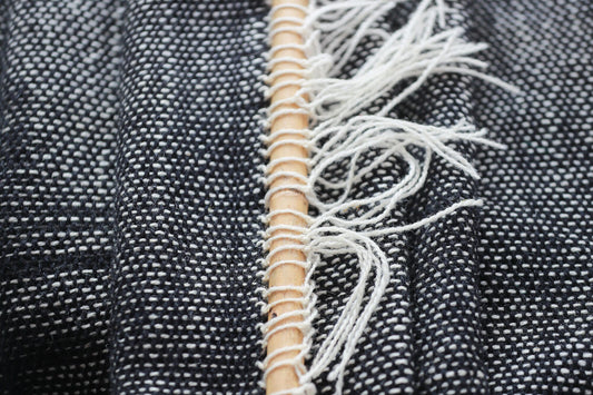 Misty Ink dark woven wall hanging styled in a minimalist Scandinavian living room