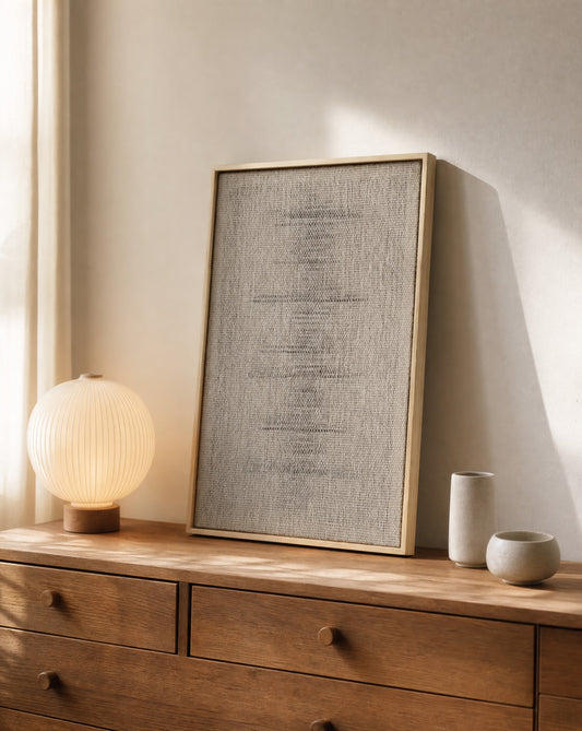 Njolle handwoven wool tapestry in a slim pine frame leaning on a wooden chest of drawers with a warm lamp, styled interior, textile wall art by Lale Studio & Shop