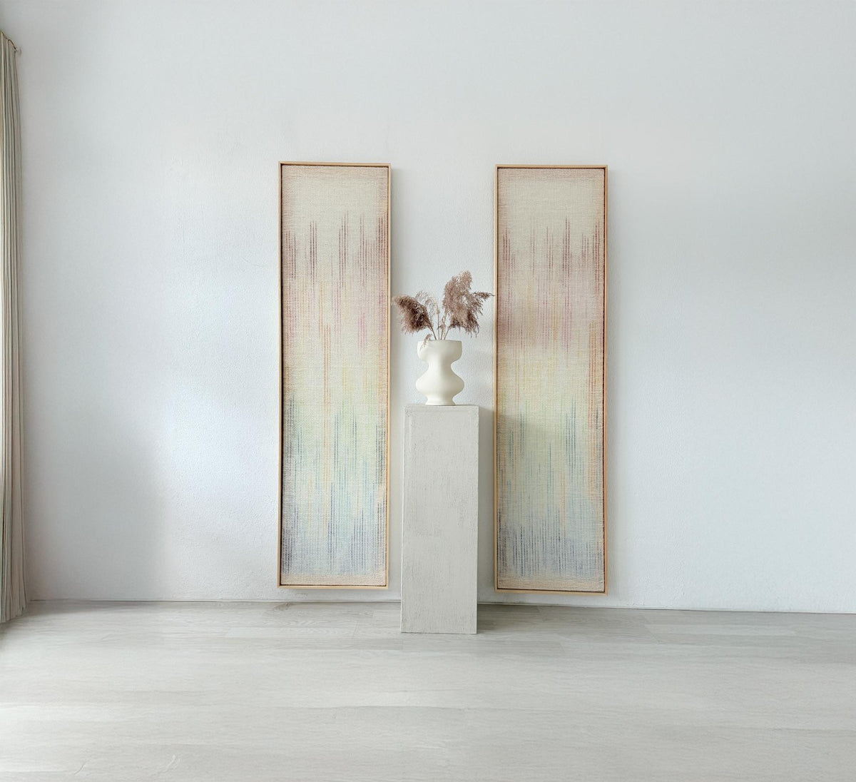 Vitre handwoven wall tapestry set featuring two pieces with a neutral wool base and a soft multicolor gradient in hues of orange, green, blue, and pink. A minimalist and artistic fiber art design perfect for enhancing contemporary or bohemian interiors.