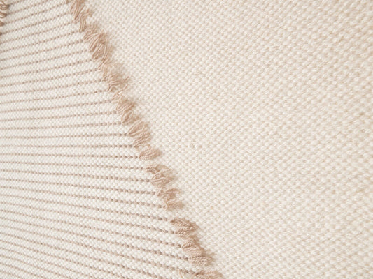 Rombo handwoven wool tapestry shown hanging on a wall