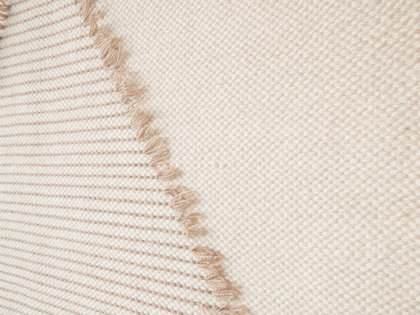 Rombo handwoven wool tapestry shown hanging on a wall