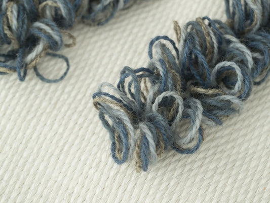 Luna handwoven wool tapestry shown hanging on a wall
