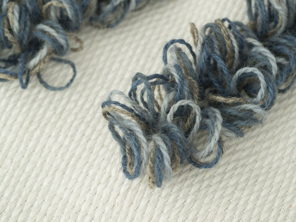 Luna handwoven wool tapestry shown hanging on a wall