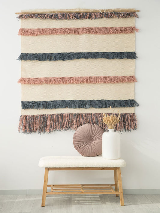 Pipi handwoven wool tapestry shown hanging on a wall
