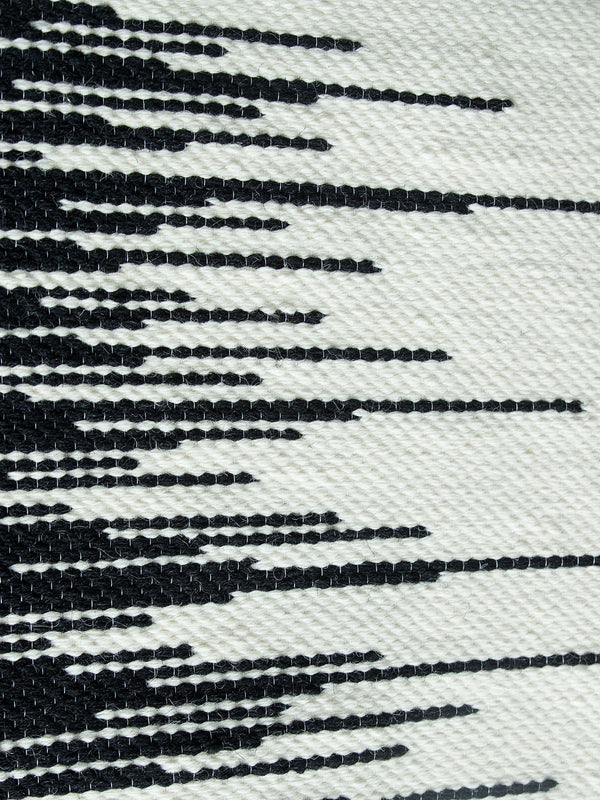 Zebra handwoven wool tapestry shown hanging on a wall