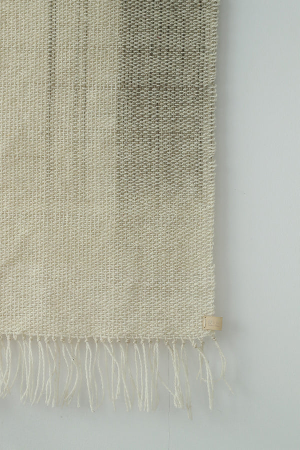 Surge handwoven wool tapestry shown hanging on a wall