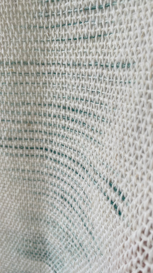 Matcha handwoven wool tapestry shown hanging on a wall