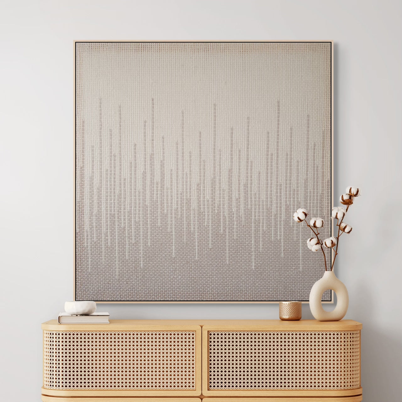 Minimalist handwoven tapestry with vertical gradient lines in neutral tones, framed and displayed above a wooden console, perfect for modern interiors.