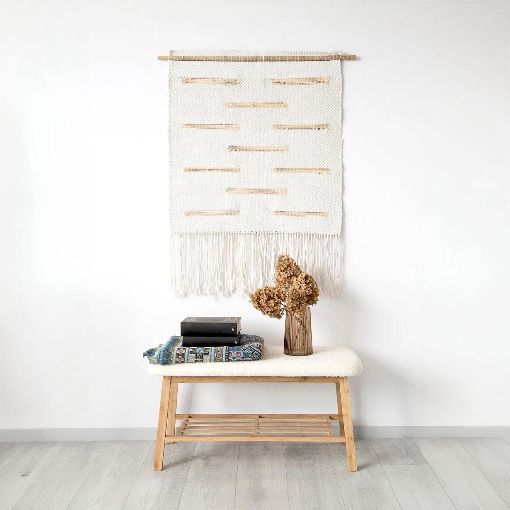 Handwoven wall tapestry with natural cotton and bamboo accents, featuring fringe details, perfect for boho and minimalist home decor.