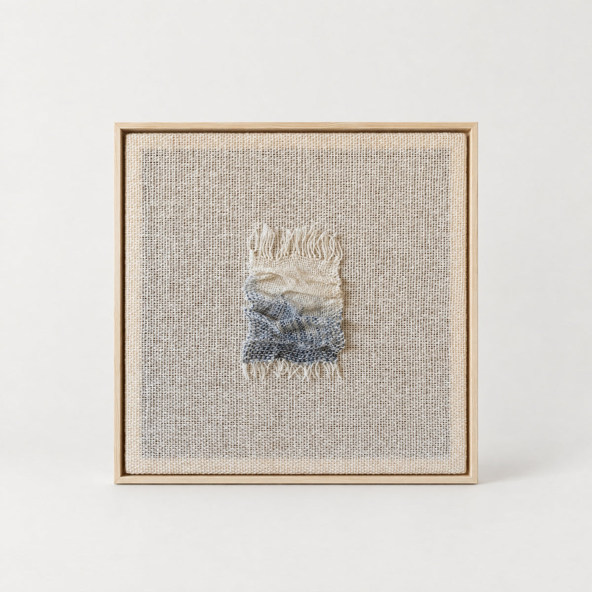 Aestus handwoven wool sculpture with a cream and slate blue folded relief on an open woven wool base in a slim natural pine frame, Lale Studio & Shop