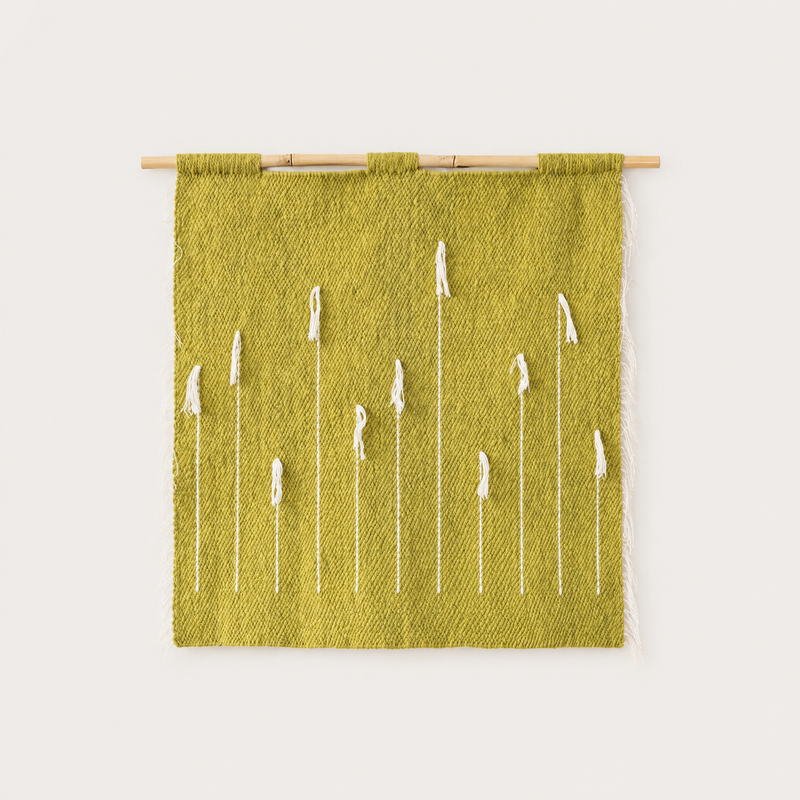 Green Denti di Leone handwoven olive wool wall hanging with white dandelion motif on bamboo rod, packshot, Lale Studio & Shop