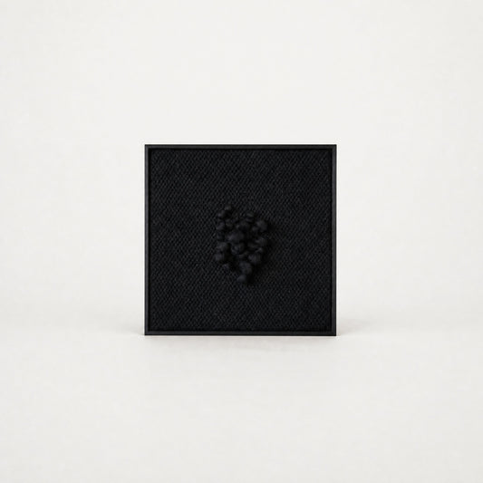 Enigma sculptural handwoven two-ply wool tapestry in deep black with raised relief in a slim black ebony frame, framed textile wall art by Lale Studio & Shop