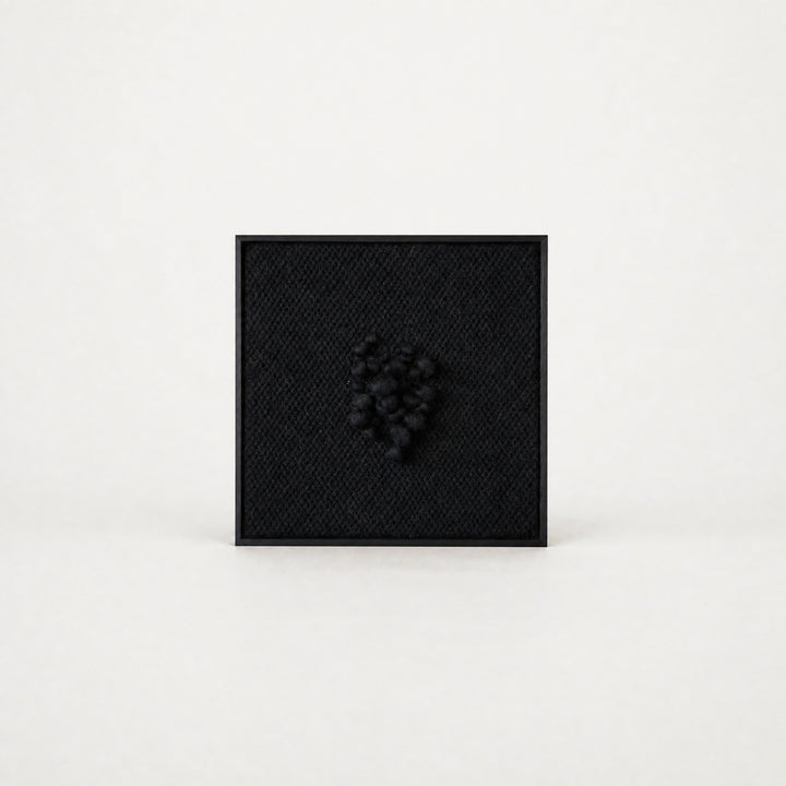 Enigma sculptural handwoven two-ply wool tapestry in deep black with raised relief in a slim black ebony frame, framed textile wall art by Lale Studio & Shop
