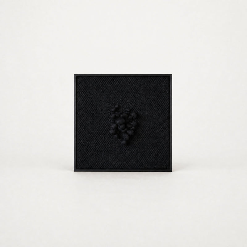 Enigma sculptural handwoven two-ply wool tapestry in deep black with raised relief in a slim black ebony frame, framed textile wall art by Lale Studio & Shop
