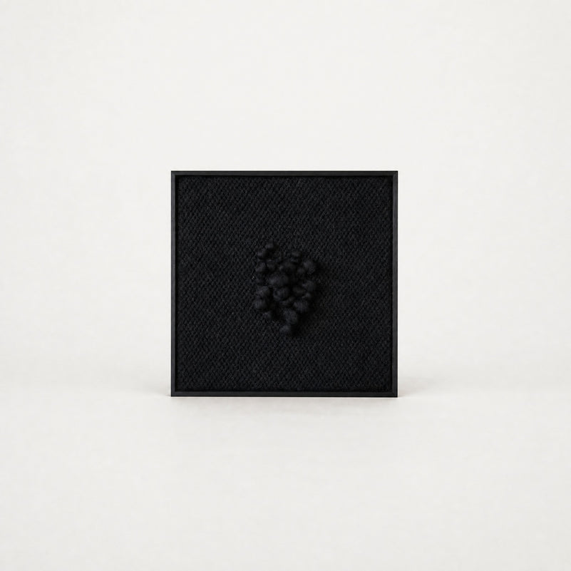 Enigma sculptural handwoven two-ply wool tapestry in deep black with raised relief in a slim black ebony frame, framed textile wall art by Lale Studio & Shop