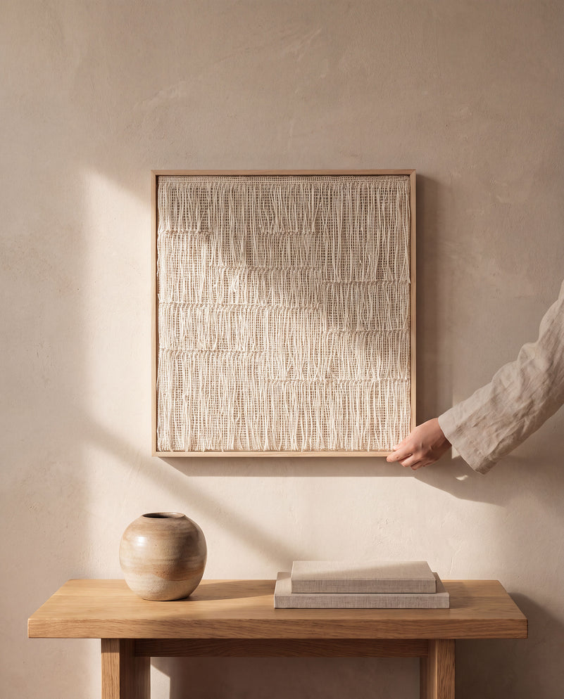 Estheté framed handwoven two-ply wool tapestry in a natural wood frame on a plaster wall, Japandi wall art by Lale Studio & Shop