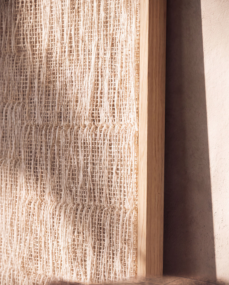 Detail of Estheté handwoven two-ply wool textile with vertical threads meeting the wood frame edge, by Lale Studio & Shop