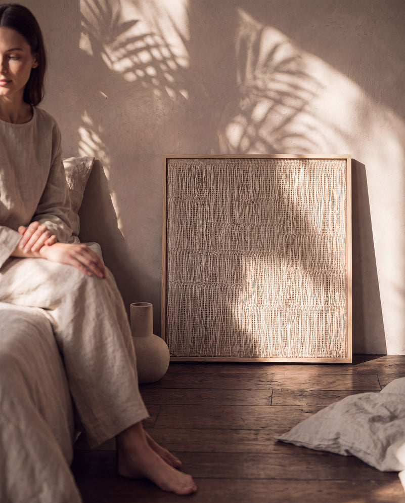 Estheté large framed two-ply wool tapestry shown beside a seated person for scale, bedroom wall decor by Lale Studio & Shop