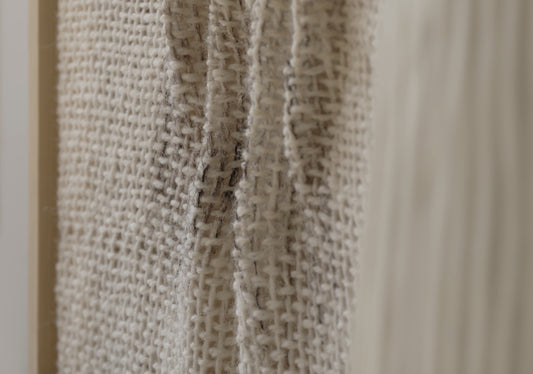 Falla handwoven wool tapestry shown hanging on a wall
