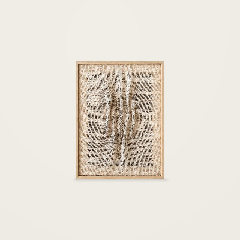 Falla — handwoven wool relief with sculptural folds and dark accents in a natural wooden frame, front view.