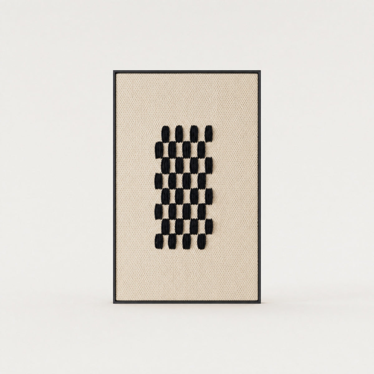 Framed II Black Pattern handwoven two-ply wool tapestry with a deep black geometric grid on a cream ground in a slim pine frame, framed textile wall art by Lale Studio & Shop