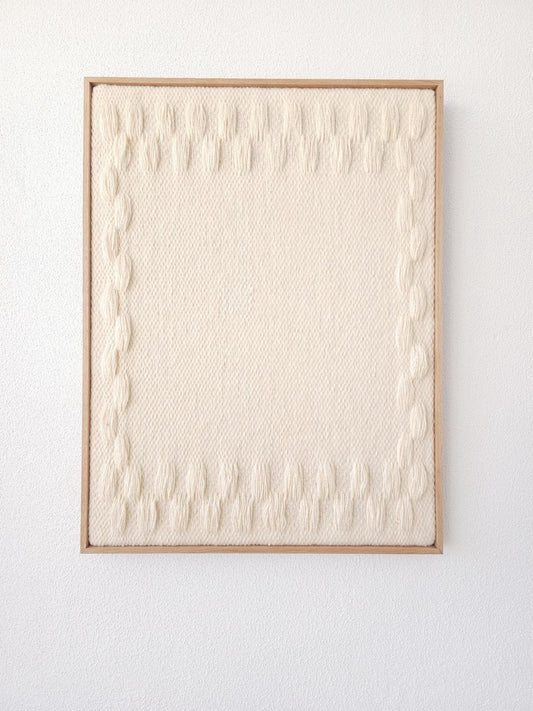 Harmony Frames handwoven wool tapestry shown hanging on a wall