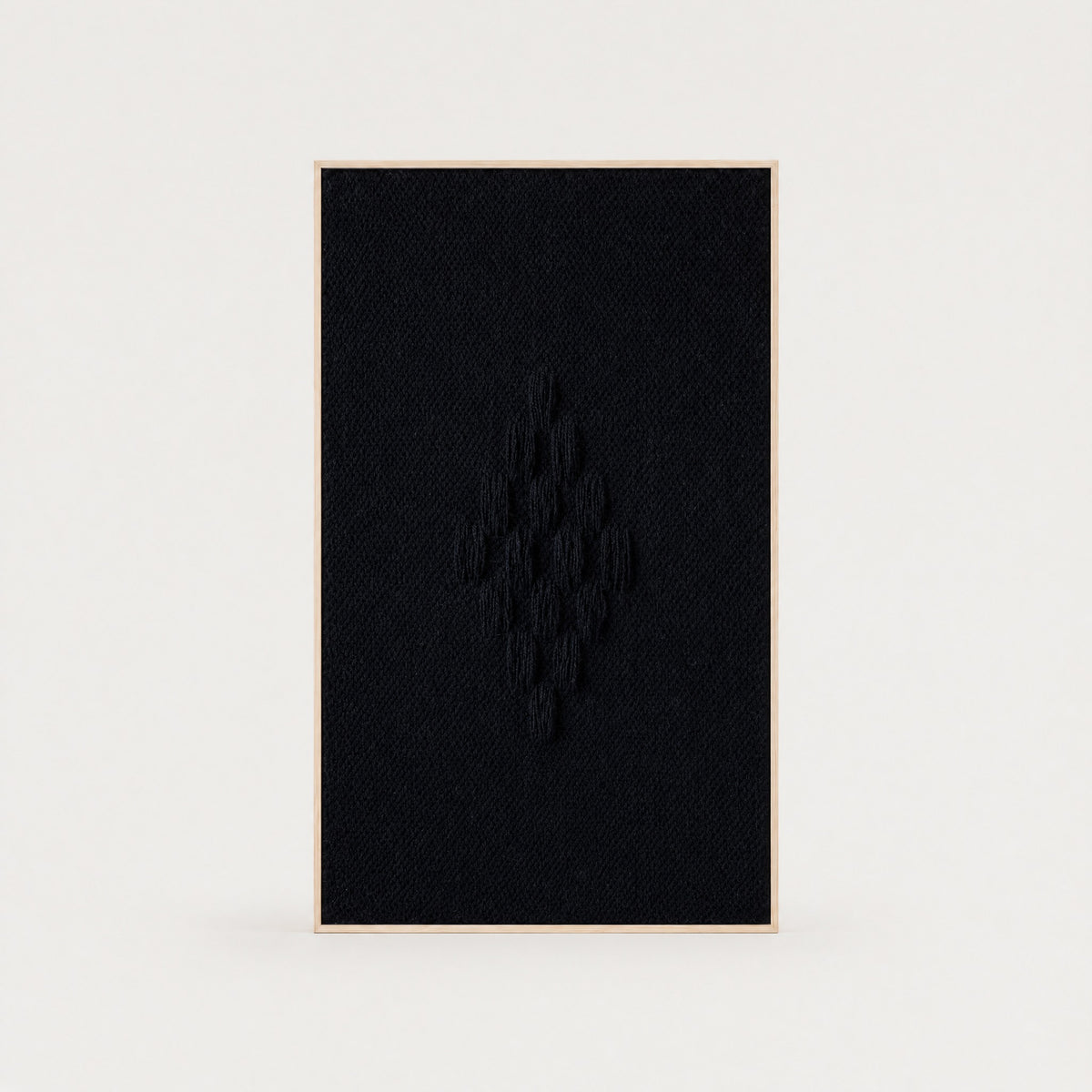 Framed VII Black handwoven two-ply wool tapestry with a raised structured deep black weave in a slim pine frame, framed textile wall art by Lale Studio & Shop