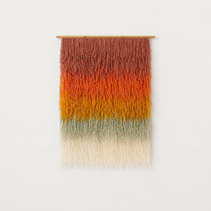 Gerbena handwoven multicolor ombre shaggy wool wall hanging on a bamboo rod, terracotta to sage gradient studio packshot — Lale Studio & Shop