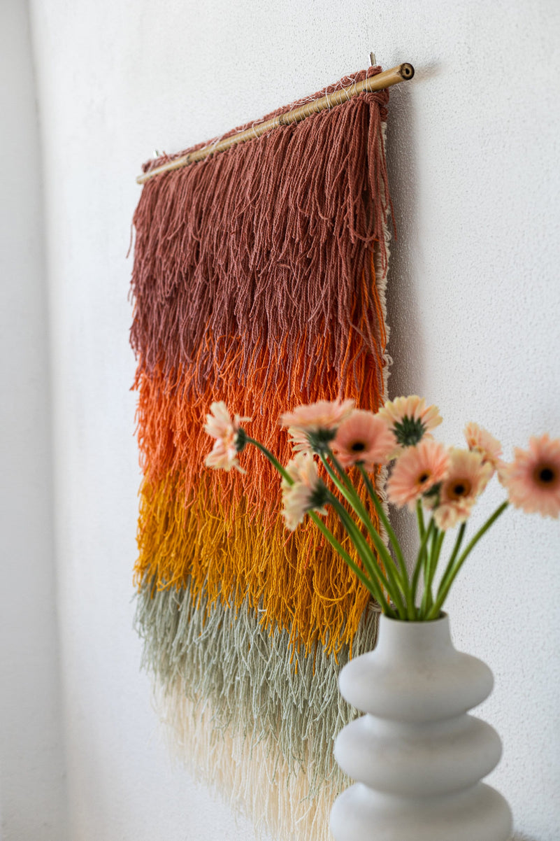 Gerbena handwoven wool wall hanging in a bright living room setting — colourful ombre textile art by Lale Studio & Shop