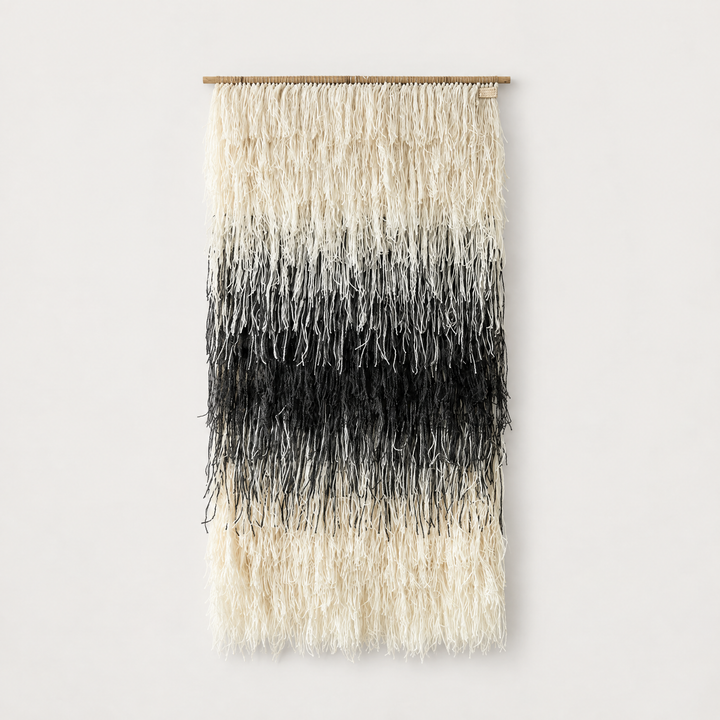 Gerhana shaggy handwoven wool wall hanging in natural cream and black on a bamboo rod, Lale Studio & Shop