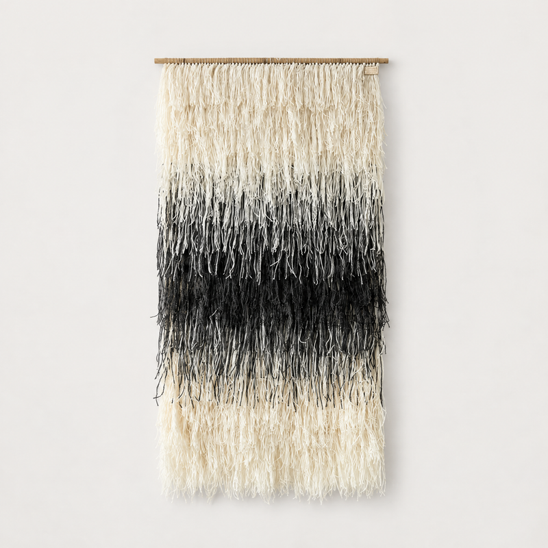 Gerhana shaggy handwoven wool wall hanging in natural cream and black on a bamboo rod, Lale Studio & Shop