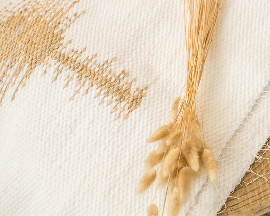 Gold Music handwoven wool tapestry shown hanging on a wall