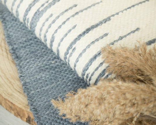 Maris handwoven wool tapestry shown hanging on a wall
