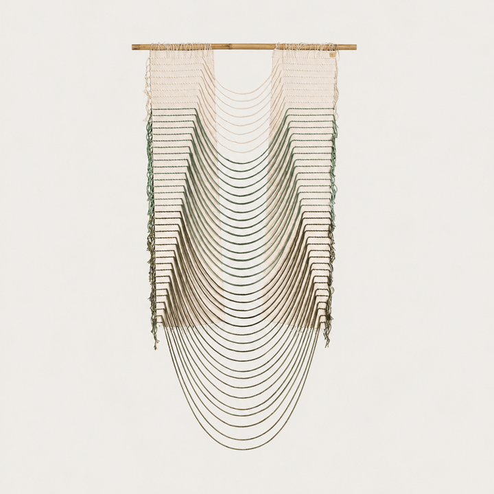 Green Urania handwoven cotton rope wall hanging with cascading semi circles in natural cream and soft green on a bamboo rod, Lale Studio & Shop
