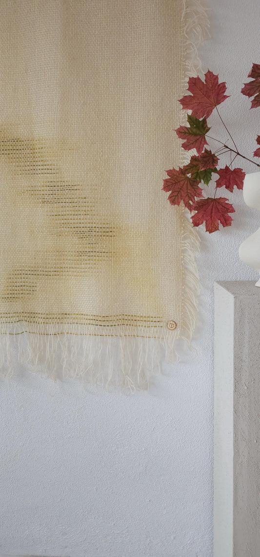 O’Mua Verde handwoven wool tapestry shown hanging on a wall