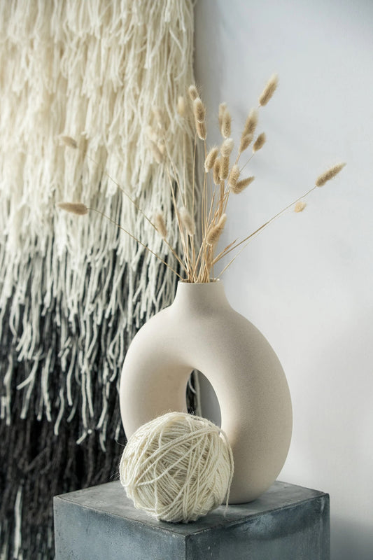 Gerhana handwoven wool tapestry shown hanging on a wall