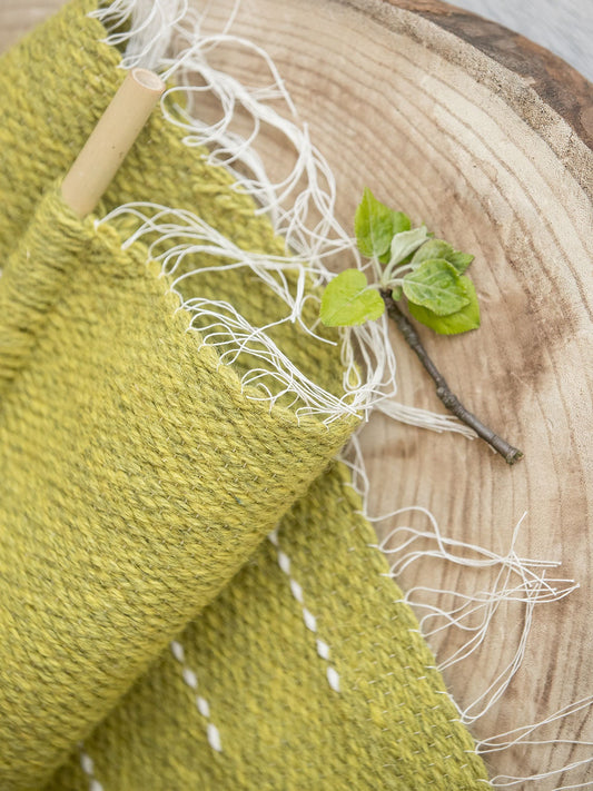 Denti Di Leone handwoven wool tapestry shown hanging on a wall