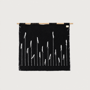 Black Denti di Leone handwoven wall hanging in black and white on a bamboo rod, Lale Studio & Shop