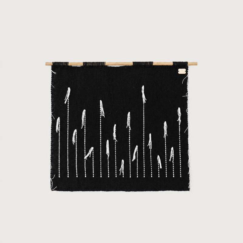 Black Denti di Leone handwoven wall hanging in black and white on a bamboo rod, Lale Studio & Shop