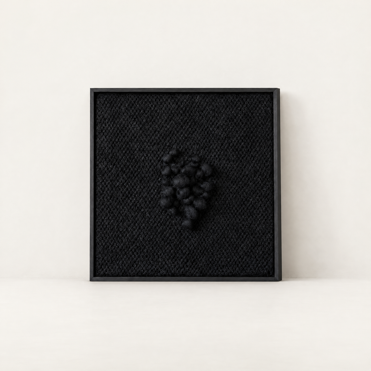Enigma black sculptural handwoven two-ply wool tapestry in a slim black wood frame, Lale Studio & Shop