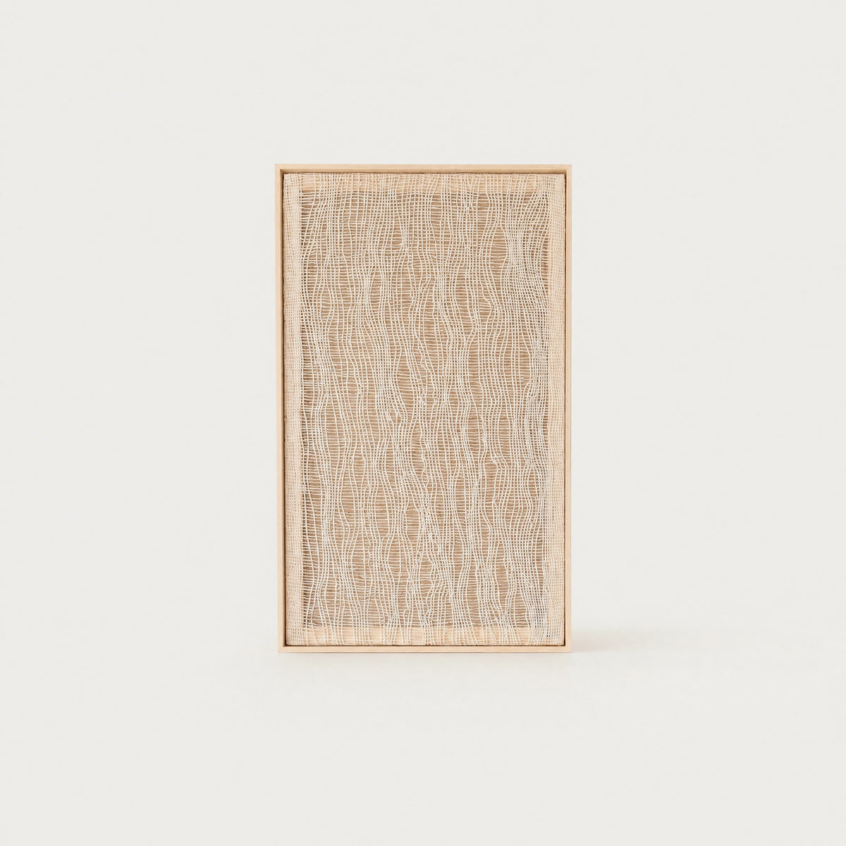 Imperfectio II handwoven wool tapestry in soft beige with a delicate light airy open weave in a slim pine frame, framed textile wall art by Lale Studio & Shop