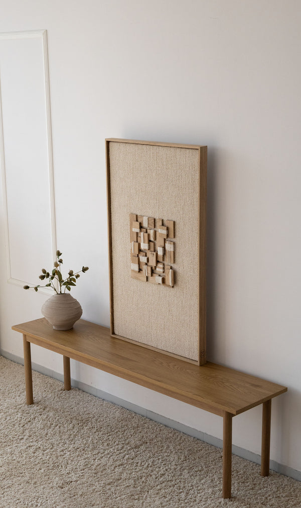 Inlay handwoven wool and oak tapestry shown hanging on a wall