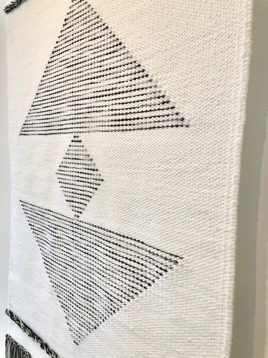 Kanso handwoven wool tapestry shown hanging on a wall
