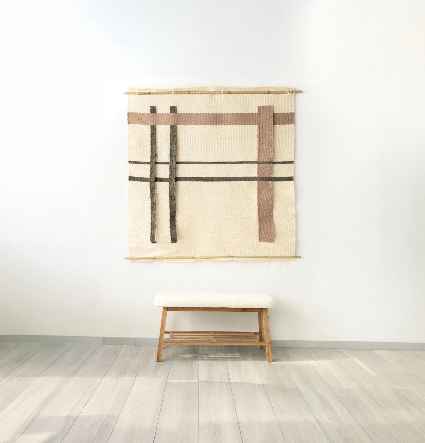 Minimalist beige wall tapestry with geometric lines and rectangular patterns, suspended on a bamboo rod, perfect as a modern or Japandi-style wall decor piece.